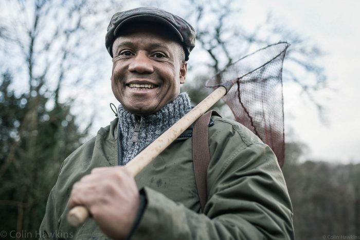 Portrait photography of middle aged black male holding net on shoulder by photographer Colin Hawkins