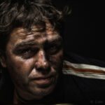 Lifestyle portrait photography of dirty biker by Colin Hawkins