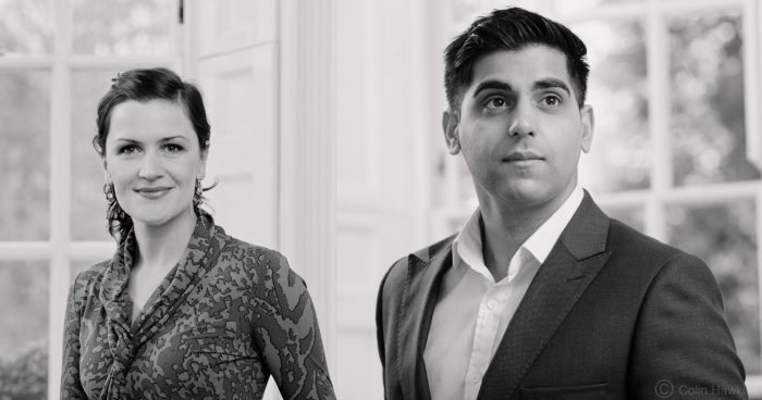 Balck and white portraits of two office workers against window back drop