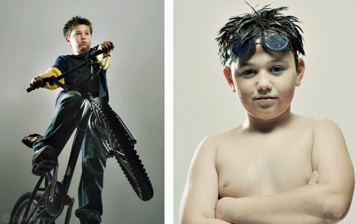 Two portraits of the same active boy in the studio for healthcare campaigns by Colin Hawkins. Left image the boy is pulling a wheelie on a bike. Right image the boy is wearing swimming goggles & looking confident