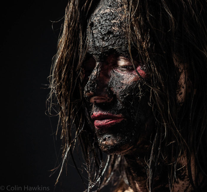 Portrait of a Woman covered in mud with bight red lipstick from the Fine Art Photography series by Three Collaborate