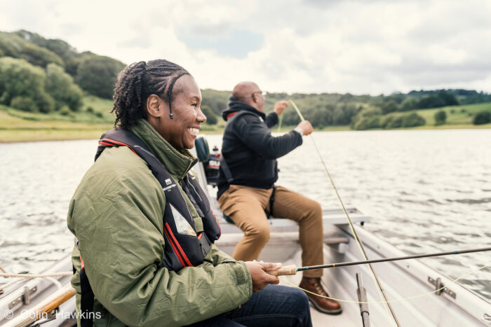 lifestyle location photography by Colin Hawkins of black couple fishing on reservoir in Somerset