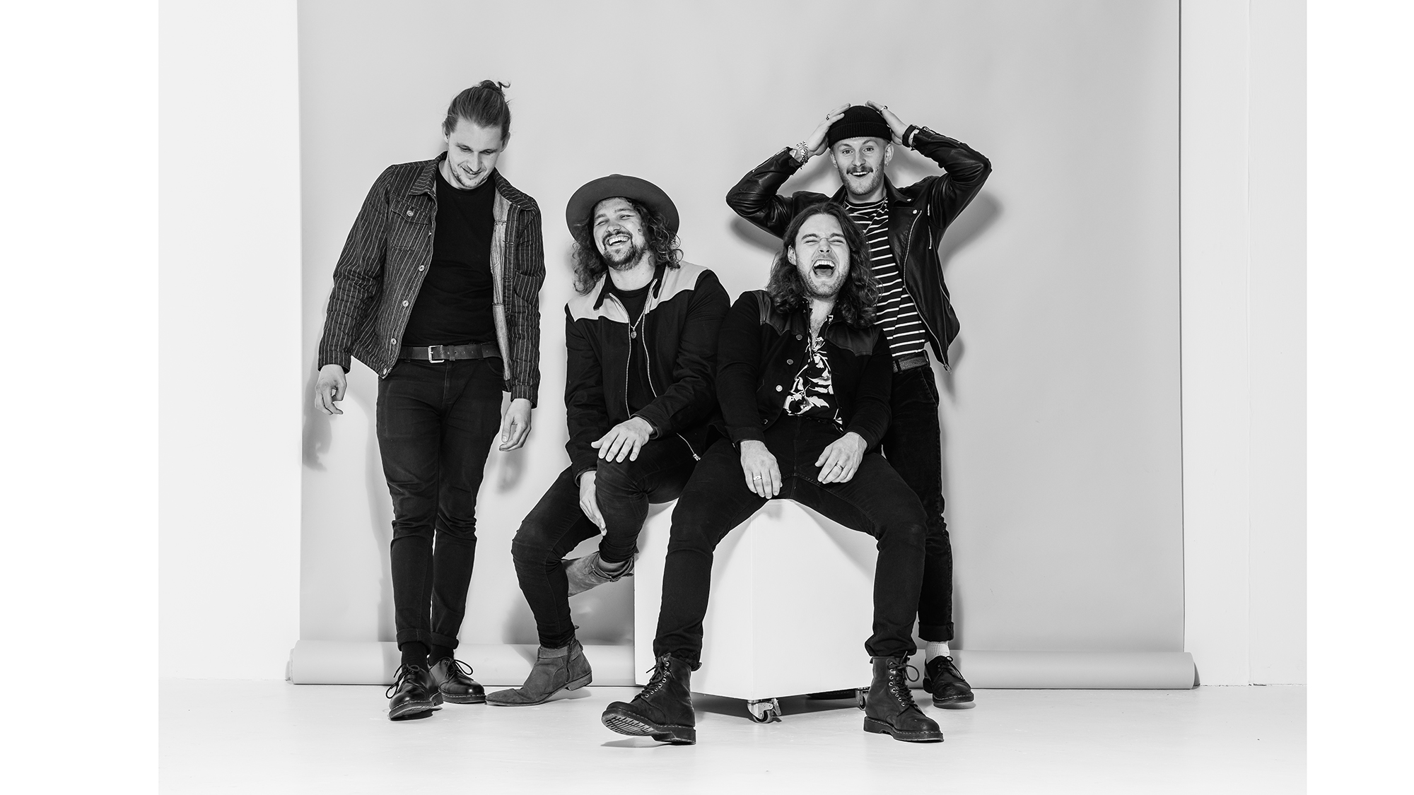 Black & white band promotional photography of Novatines in the studio on a plain background