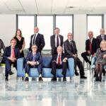 Group of CEO's and business managers on location in empty office building by photographer Colin Hawkins