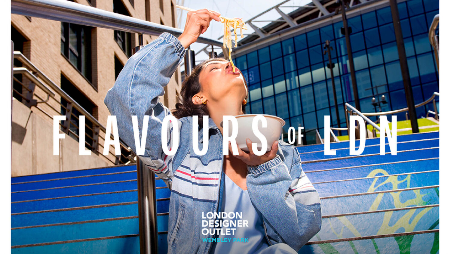Woman weating noodles at Wembly for London Deigner Outlet by colin Hawkins