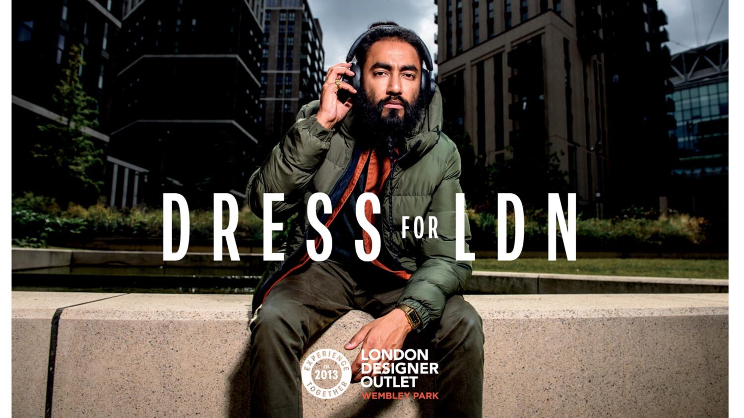 Man in warm clothing in cityscape for London Designer Outlet Campaign